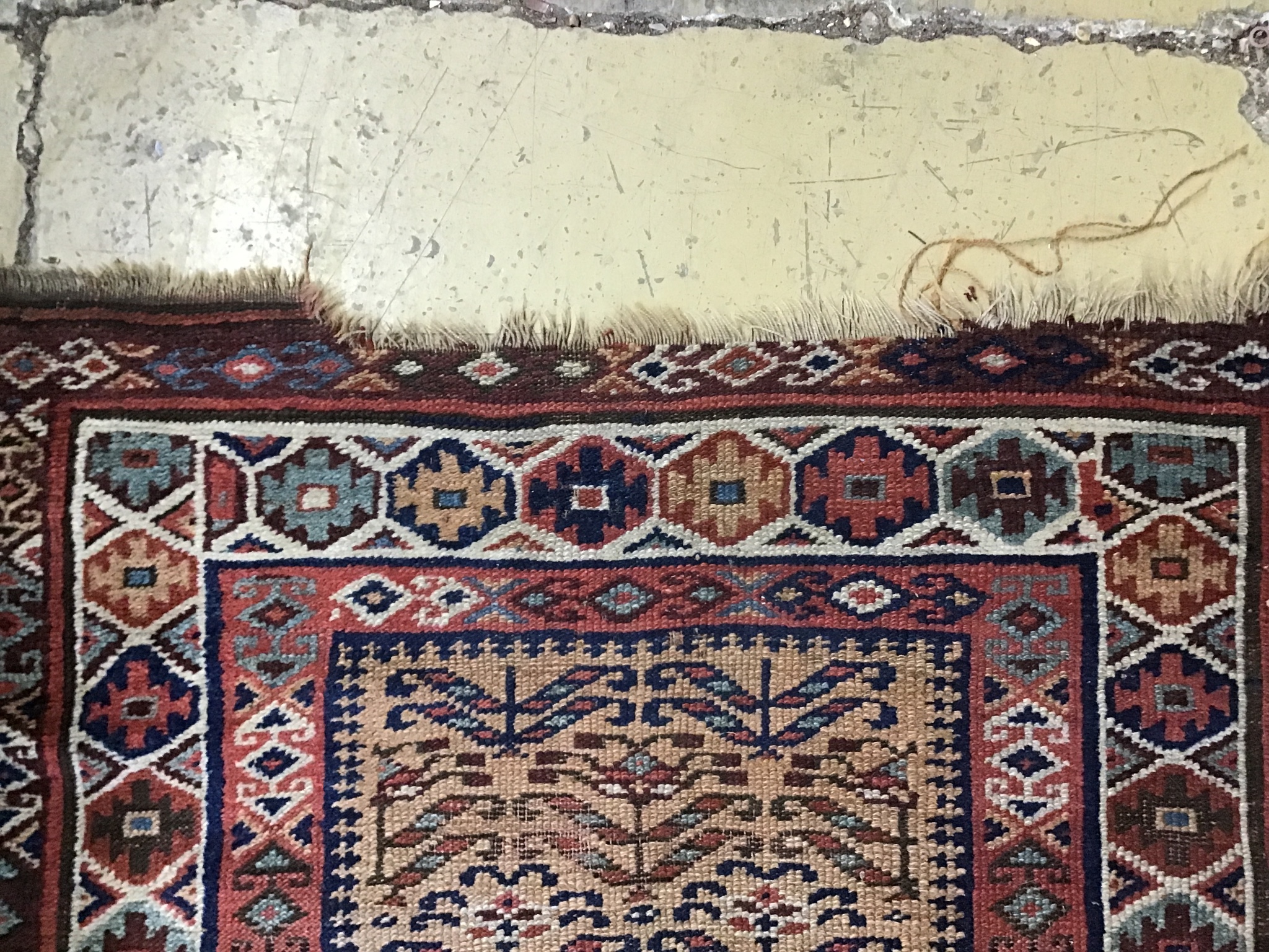 An antique Caucasian brick red ground runner, 410 x 100cm